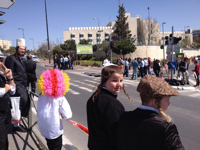 Children wearing Purim costumes near the scene of the terror attack in Jerusalem